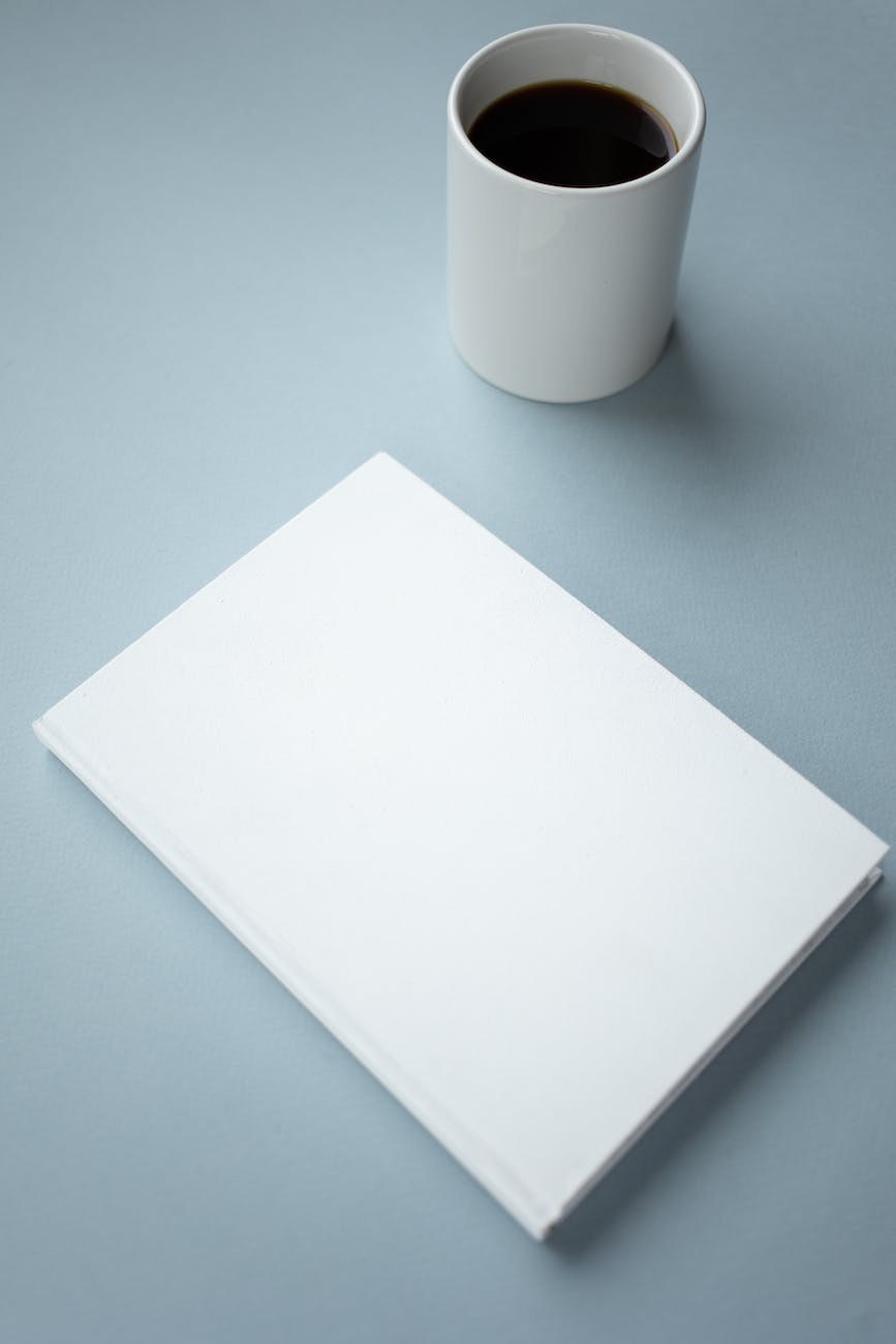 book with blank cover and cup of coffee