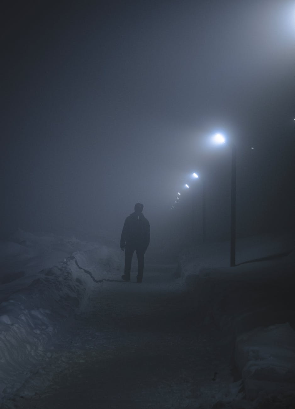 a person standing on the street at night